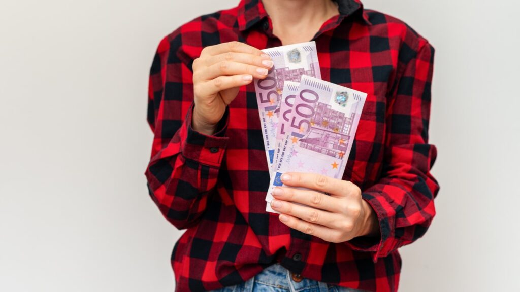 Person holding euros