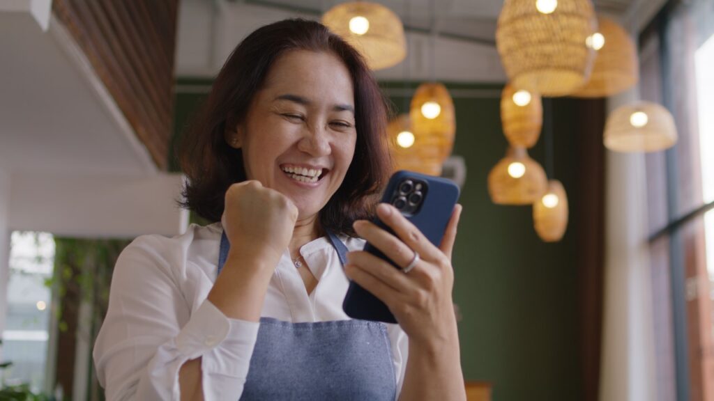 Woman happy looking at phone