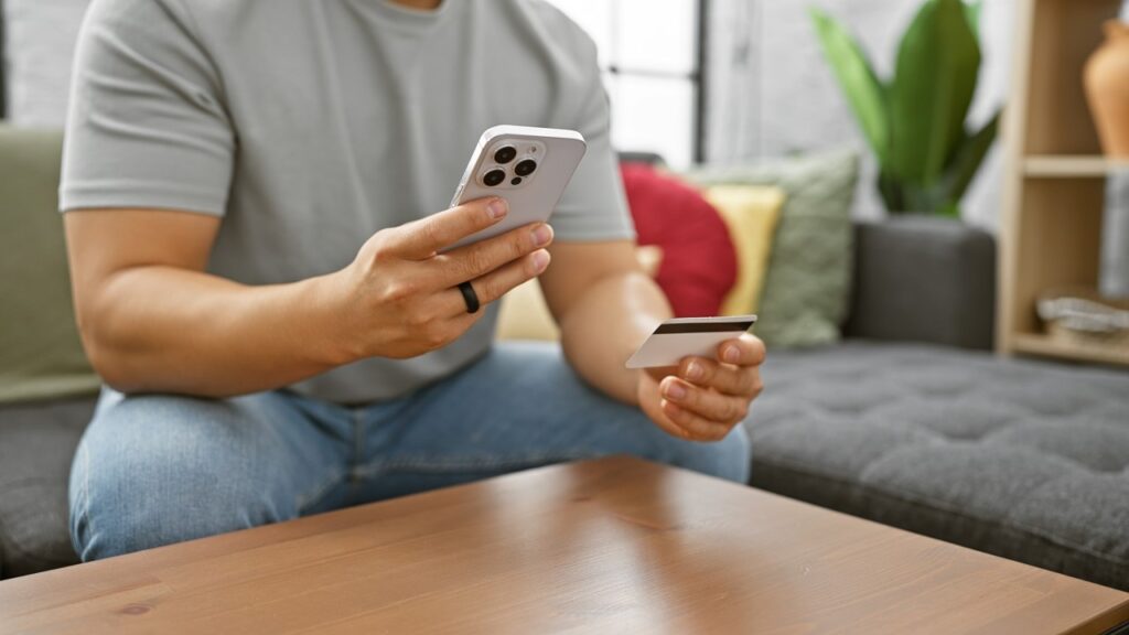 Man holding card and phone